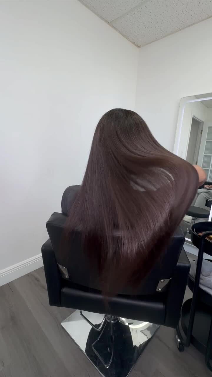 Long dark hair with deep shine and movement after a smoothing service at the studio